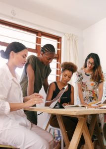 Diverse team collaborating around a table discussing lifestyle trends.