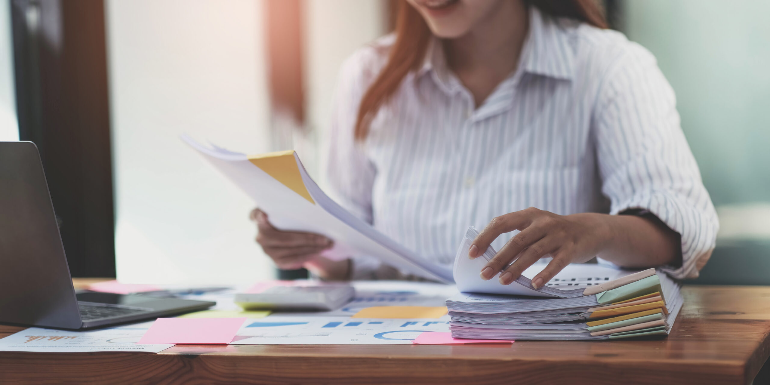 Woman reviewing business documents and student data for school administrators
